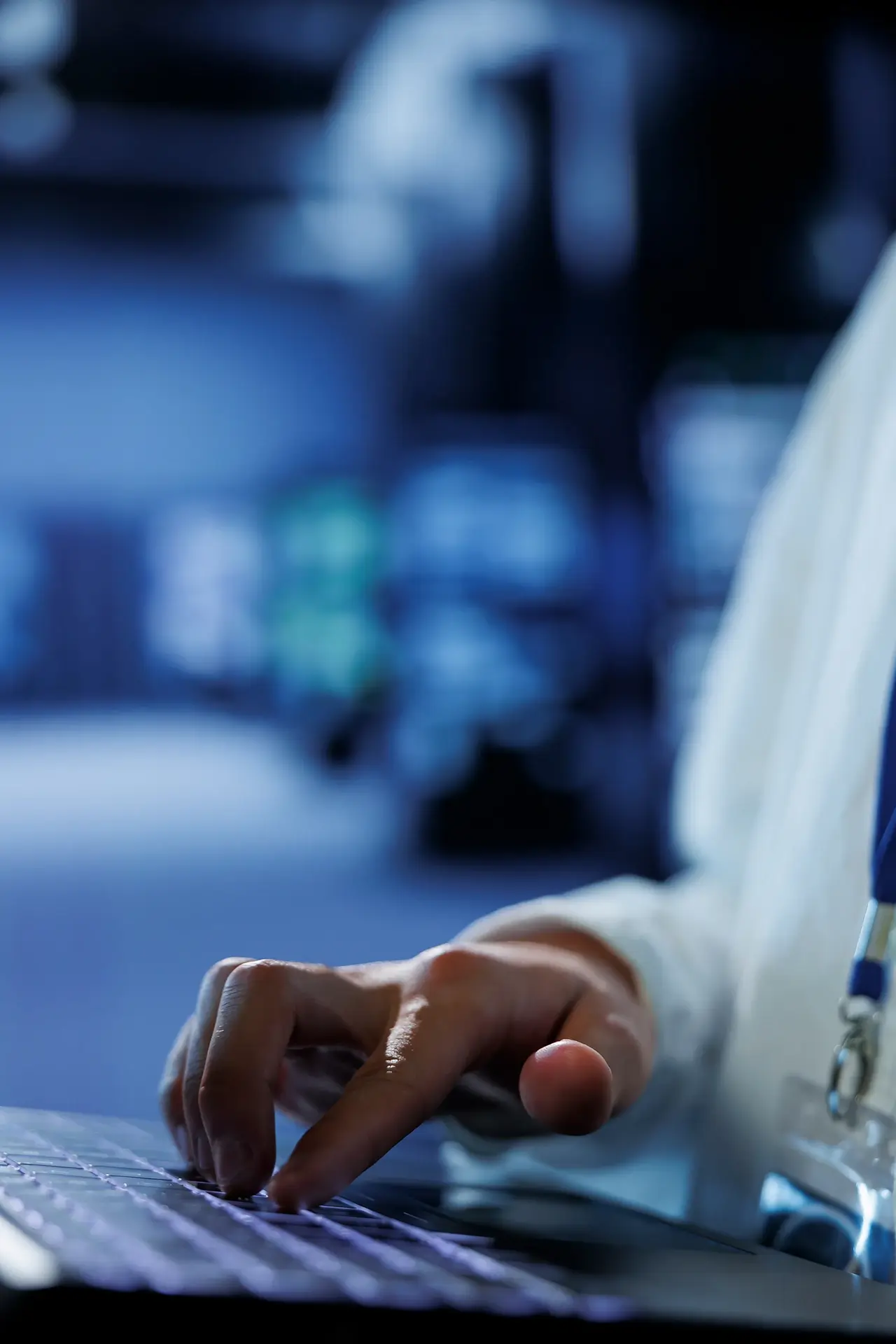 knowledgeable-admin-data-center-uses-laptop-prevent-system-overload-peak-traffic-periods-adept-expert-server-hub-ensuring-enough-network-bandwidth-smooth-operations-close-up